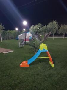 a plastic slide in the grass at night at Agriturismo Paparanza in Valguarnera Caropepe