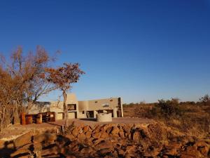 a house sitting on top of a rocky hill at Lodge Twentyfour Mabalingwe Nature Reserve in Warmbaths