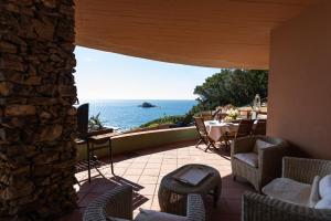 an outdoor patio with a view of the ocean at Villa Capo Boi in Villasimius
