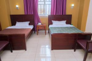 Postel nebo postele na pokoji v ubytování Diamonds Hotel Kampala