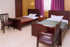 Postel nebo postele na pokoji v ubytování Diamonds Hotel Kampala