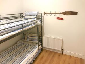 a bunk room with two bunk beds and a hanger at Ridge Cottage Portrush in Portrush