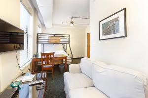 a living room with a white couch and a table at Temple Place 6th Floor in Boston