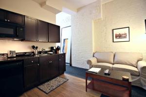 a living room with a couch and a kitchen at Temple Place 6th Floor in Boston