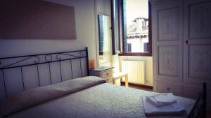 a bedroom with a large bed and a window at B&B La Terrazza Dei Miracoli in Venice