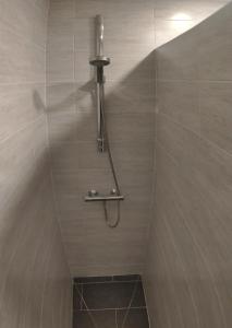 a shower with a shower head in a bathroom at Maison de ville centre Nogent le Rotrou in Nogent-le-Rotrou
