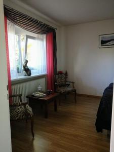 a living room with a table and a window at Familiehuis Dolve 2 in Hartheim