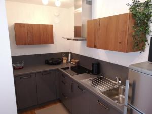 a small kitchen with a sink and a refrigerator at Apartma Lucijana in Mojstrana