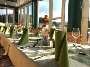 a long table with a white table cloth and glasses at Narnhoferwirt in Sankt Jakob im Walde