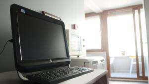 a computer desk with a monitor and keyboard at Stay Inn Taksim Hostel in Istanbul