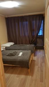 a bedroom with two beds and a window at Adart Apartment in Narva