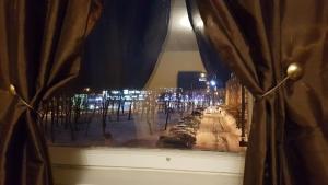 a window with a view of a street at night at Adart Apartment in Narva