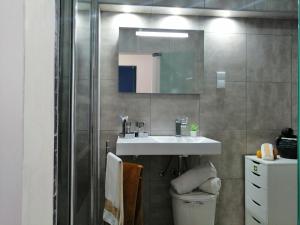 a bathroom with a white sink and a shower at Livelove Sea in Santa Cruz +7 photos