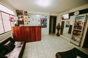 a waiting room with a counter in a store at Hotel Las Viñas in Huánuco