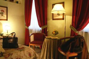 a hotel room with a bed and a table and a lamp at JOIVY Together Florence Secret Nest in Florence