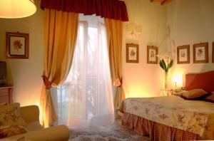 a bedroom with a bed and a window with curtains at JOIVY Together Florence Secret Nest in Florence