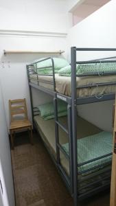 a couple of bunk beds in a room with a chair at 18floor condo close to MRTwith 2 bedrooms in Hua mak in Bangkok