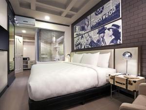 a bedroom with a large white bed and a tv at Summit Hotel Magnolia in Manila +87 photos