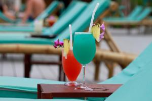two cocktails sitting on top of a table at Phi Phi CoCo Beach Resort in Phi Phi Islands