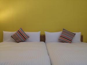 Posteľ alebo postele v izbe v ubytovaní Hengchun Inn