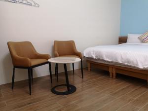 Posteľ alebo postele v izbe v ubytovaní Hengchun Inn