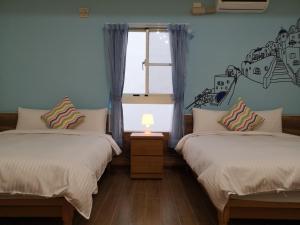 Posteľ alebo postele v izbe v ubytovaní Hengchun Inn