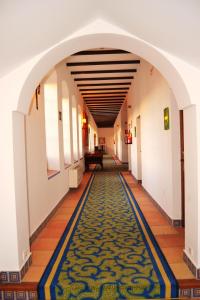 a large room with a blue floor and white walls at Hotel El Carmen in Puente Genil
