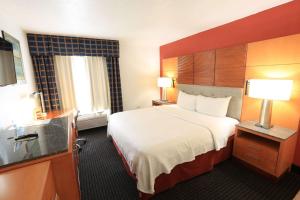 a hotel room with a large bed and a window at Days Inn by Wyndham Calumet Park in Calumet Park