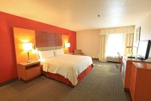 a hotel room with a bed and a television at Days Inn by Wyndham Calumet Park in Calumet Park +9 photos
