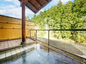 a view from the balcony of a house with water on the ground at Ryokan Chinsen-Rou in Nantan city
