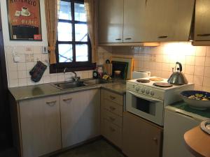 a small kitchen with a stove and a sink at Aegean Sunset in Damouchari