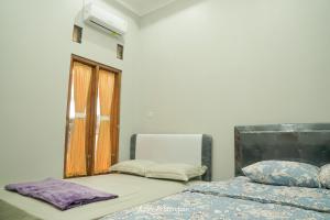 Postel nebo postele na pokoji v ubytování M Stay Guest House Jogja
