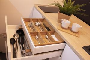 a drawer in a kitchen counter with utensils at Apartment Take a breath in Vrnjačka Banja
