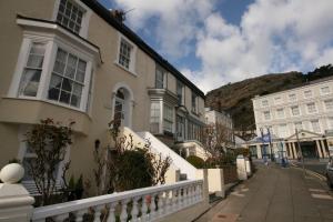 a street in a town with buildings and a mountain at The Thomas Suite in Llandudno
