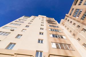 a tall white building looking up at the sky at 16 вулиця Прокоф'єва in Sumy