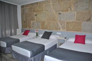 Postel nebo postele na pokoji v ubytování Hotel Junquera