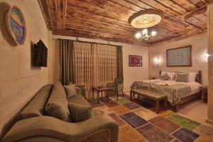 a living room with a couch and a bed at Caravanserai Inn Hotel in Goreme