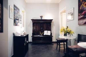 a room with a table and a wooden cabinet at Monteverdi Resort in La Spezia