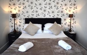a bedroom with a bed with two pillows on it at Whitburn House Hotel in Preston