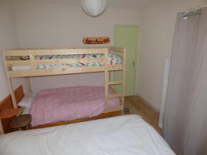 a bedroom with two bunk beds and a bed at Appartement de la cascade in Eaux-Bonnes