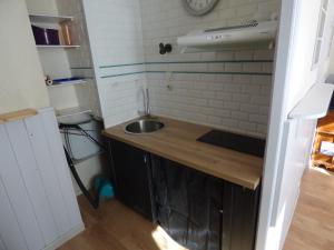 a small kitchen with a sink and a counter at Appartement de la cascade in Eaux-Bonnes