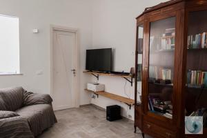 a living room with a couch and a television at B&B CASA GILANIA LAMPEDUSA in Lampedusa