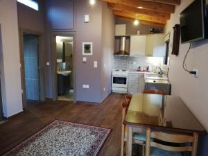 a kitchen with a table and a counter top at Rea's House Vrachati in Vrachati