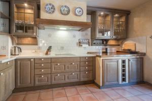 a kitchen with wooden cabinets and plates on the wall at Xalet Kotki HUT1-005472 in Canillo