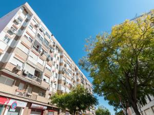 a tall apartment building with trees in front of it at Apartamento Luis de Vargas in Huelva