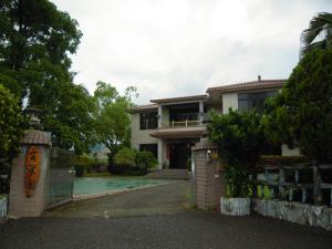 a house with a gate in front of it at Kaohsiung Meinong Rabbit Paul Homestay B&B in Meinong