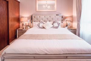 a bedroom with a large white bed with pillows at Elite Royal Apartment - Burj Residences T7 - President in Dubai