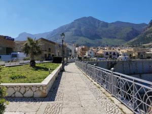 a walkway in a town next to a body of water at Mizzika Vacanze in Castellammare del Golfo