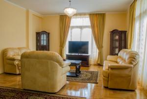 a living room with two chairs and a television at Villa Ramonte in Cetinje +21 photos
