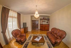 a living room with leather chairs and a table at Villa Ramonte in Cetinje